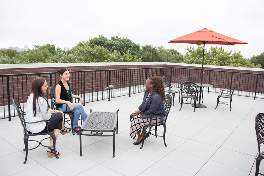 patients talking on a rooftop patio